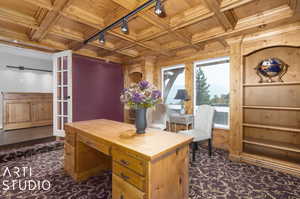 Library office area with beamed ceiling, track lighting, dark carpet, wooden ceiling, and coffered ceiling