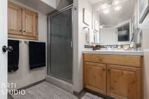 Lower Level Bathroom with vanity and an enclosed shower