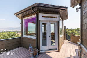 Deck with a mountain view and french doors