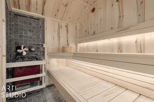 Primary bathroom sauna / steam room featuring wood walls, tile patterned floors, and wooden ceiling