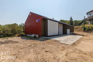 View of outbuilding featuring a garage