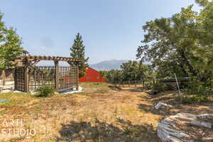 View of yard with a mountain view and a rural view