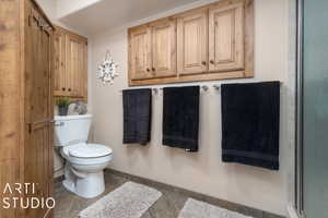 Lower Level Bathroom featuring tile patterned floors and toilet