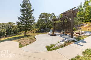 View of patio / terrace featuring a pergola and a fire pit