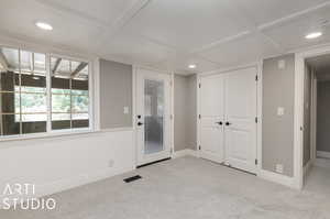 Carpeted spare room featuring coffered ceiling