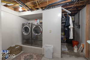 Lower Level Laundry room with separate washer and dryer and water heater