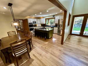 Dining area with sink and light wood-type flooring