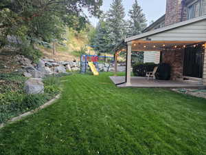 View of yard featuring a patio and a playground