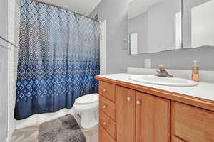 Bathroom featuring vanity, tile patterned floors, and toilet