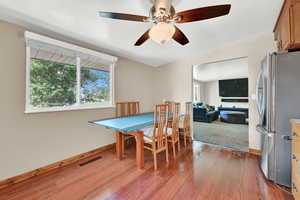 Dining room featuring a healthy amount of sunlight, ceiling fan, and hardwood / wood-style floors