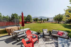 View of patio featuring a mountain view, outdoor lounge area, and a trampoline