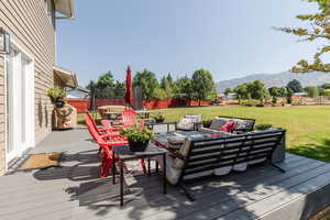 Wooden deck featuring a yard and a mountain view