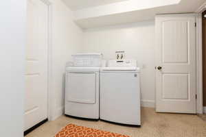 Clothes washing area featuring independent washer and dryer