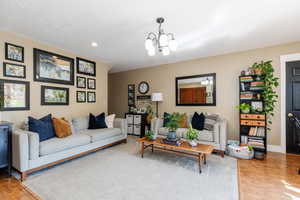 Living room with a chandelier and light hardwood / wood-style floors