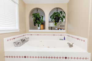 Bathroom featuring tiled bath