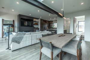 Dining room with a large fireplace and light hardwood / wood-style floors