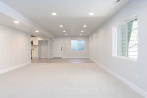 Interior space with plenty of natural light and light colored carpet