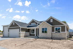 Craftsman inspired home featuring covered porch, central air condition unit, and a garage