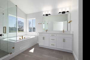 Bathroom featuring tile patterned flooring, lofted ceiling, double vanity, and plus walk in shower