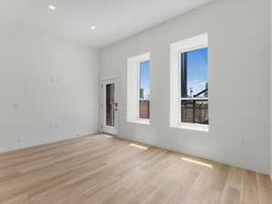 Empty room with light hardwood / wood-style flooring