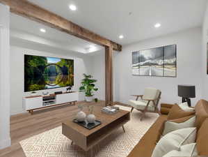 Living room with light hardwood / wood-style flooring and beam ceiling