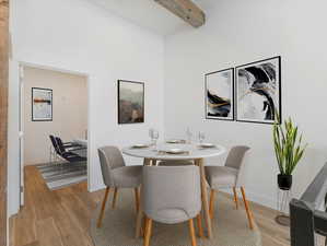 Dining space featuring beamed ceiling and light hardwood / wood-style floors