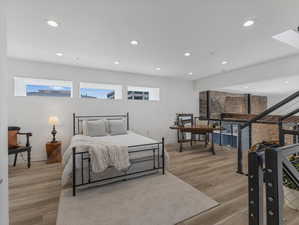 Bedroom with light hardwood / wood-style floors