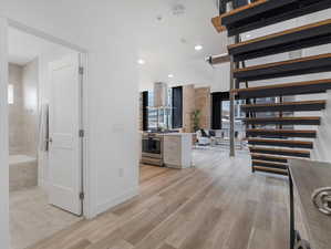 Corridor with light hardwood / wood-style flooring