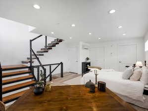 Bedroom featuring a wall mounted air conditioner and light wood-type flooring