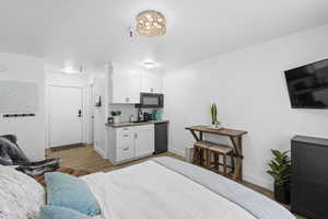 Interior space with sink, a chandelier, and light hardwood / wood-style floors