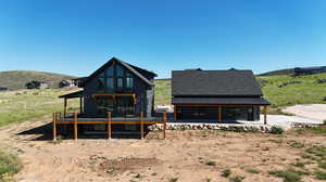 Rear view of property featuring a deck with mountain view