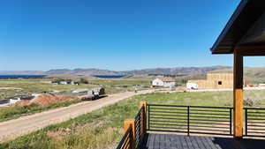 Wooden deck featuring a mountain view and a rural view