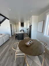 Dining room with light hardwood / wood-style flooring