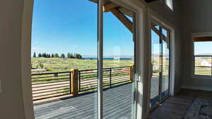 Exterior space featuring wood-type flooring, plenty of natural light, and a rural view