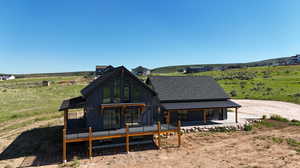 Back of house featuring a rural view