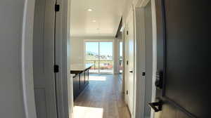 Corridor with light hardwood / wood-style floors