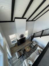 Living room featuring beamed ceiling, high vaulted ceiling, and light hardwood / wood-style floors