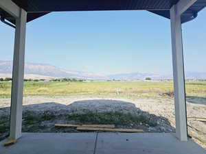 View of patio / terrace with a mountain view and a rural view