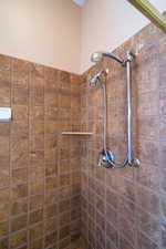 Bathroom with tiled shower and dual shower heads