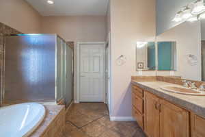 Owner Bathroom #2 with independent shower and bath, vanity, and tile patterned flooring