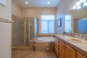 Owner Bathroom #1 with independent shower and bath, vanity, and tile patterned floors