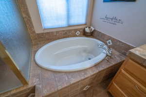 Bathroom featuring a relaxing tiled tub