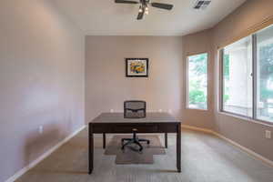 Office space featuring bay window, carpet and ceiling fan