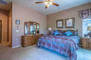 Owner Bedroom #1 featuring light colored carpet and ceiling fan