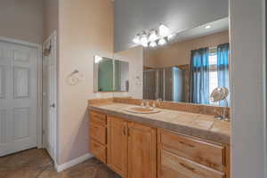 Owner Bathroom #2 with tile vanity and tile patterned flooring