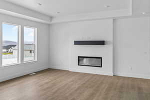 Unfurnished living room featuring hardwood / wood-style floors