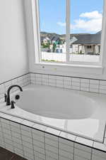 Bathroom featuring tiled tub