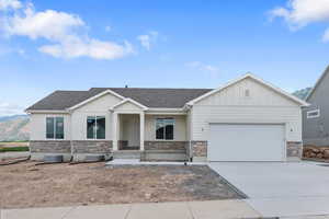 View of front of house with a garage and central AC unit