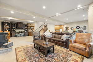 Carpeted living room featuring a wood stove