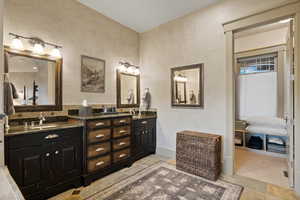 Bathroom with double vanity and tile patterned flooring